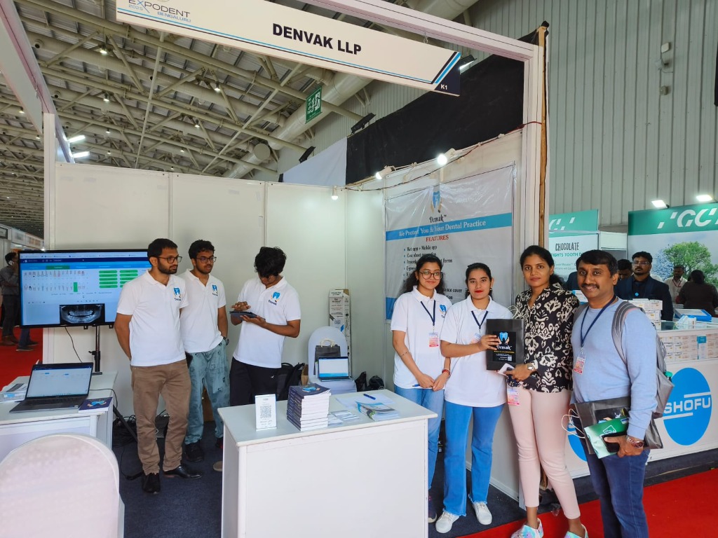 Denvak team demonstrating the software live at Expodent Bengaluru with display monitors